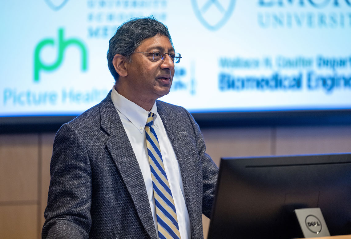 Ravi V. Bellamkonda speaking at a podium